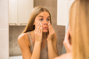 a woman touching her face