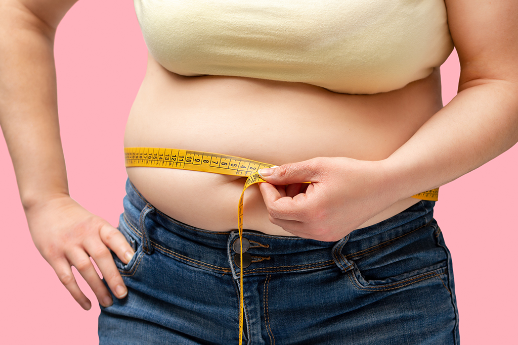 a person measuring her waist