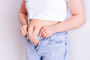 a woman wearing jeans and a white shirt