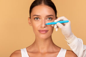 a woman with a blue marker on her face